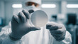 © photo for everything - Scientist in sterile suit holds advanced silicon wafer in cleanroom environment, showcasing precision manufacturing and high-tech material research