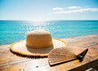 © Key Ra - wide-brimmed straw sun hat and a hand fan on the table
