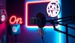 © Aishah05 - Modern podcast studio setup with condenser microphone and neon 'On Air' signs.