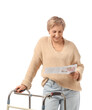 © Pixel-Shot - Mature woman with walker reading newspaper on white background