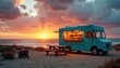 © miss irine - Teal food truck sits on sand dunes by ocean. Generator and picnic table nearby. Sunset paints sky with orange and pink clouds over calm water. Warm lights glow from truck window.