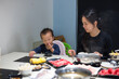 © leungchopan - Mother and baby enjoying hotpot meal together