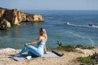 © Angelov - A woman is seen practicing yoga surrounded by the serene and picturesque environment