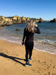 © Angelov - Young mature blonde caucasian woman outdoor in a beach in a sunny day. Praia da Vigia, Cantabria, portugal, Europe.