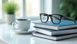 © Pete - Stack of books with glasses rests on desk. Coffee cup sits nearby. Represents learning and professional growth. Minimalist setting with indoor plant.