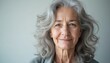 © Pete - Elderly woman with gray wavy hair and kind smile. Mature female face with wrinkles shows wisdom and experience. She has natural beauty and healthy skin.