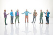 © photosaint - Seven miniature figurines stand in a circle with one figure gesturing while others listen at a white background
