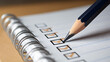 © photo for everything - Close-up of a pencil marking a checkbox on a spiral notebook, symbolizing task completion, planning, or assessment diligence