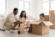 © Meow Creations - Happy family playing with cardboard boxes in new home