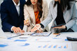 © laddawan - Business team collaboration discussing working analyzing with financial data and marketing growth report graph in team, presentation