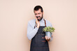 © luismolinero - Man holding a plant over isolated background with toothache