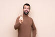 © luismolinero - Man over isolated background smiling and showing victory sign