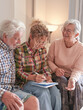 © luciano - Smiling Senior couple and Caregiver Sharing a Moment sitting together on sofa at home. Concept of assistance and help to our elderly