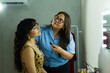 © AntonioDiaz - Makeup professional working on a young woman's eyelashes, creating a beautiful look behind the scenes