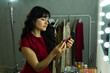 © AntonioDiaz - Young woman choosing lipstick shades for makeup getting ready backstage in a dressing room