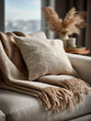 © Saktanong - Cozy neutral toned throw blanket and textured cushion on a sofa with blurred background