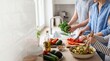 © Benjamin - Family cooking healthy salad together in modern kitchen parents and child preparing fresh vegetables organic food lifestyle teamwork wellness home meal nutrition happiness togetherness daily routine