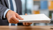 © pjjaruwan - Handed stack of paper document file on desk in office environment conveying legal compliance or paperwork delivery with neutral tone