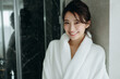 © tokyo studio - 高級ホテルで微笑むバスローブ姿の30代女性