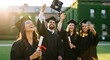 © Benjamin - A group of friends in graduation gowns and caps celebrating their achievement on a university campus