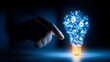 © kaliel - Hand pointing toward a glowing light bulb made of network lines representing innovation, problem solving, and smart ideas.