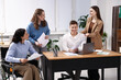 © New Africa - Inclusion. Woman in wheelchair and her colleagues working in office