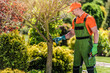 © Tomasz Zajda - Gardener Works on Tree Care in Sunny Park Setting