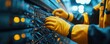 © zong - Gloved hands in yellow jacket connecting network cables to a server patch panel in a blue-lit data center with blinking orange lights, focused and precise maintenance work