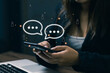 © saranyoo - Social communication concept with woman using smartphone and chat bubbles, representing messaging app, online conversation, social media interaction, digital lifestyle and mobile communication.