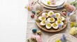 © Bounpaseuth - Easter Table of Delights: A close-up shot presents a festive and artful arrangement of Easter brunch featuring deviled eggs, charming flowers, and bunny figurines.