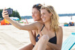 © auremar - young women on the beach taking selfie