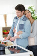 © auremar - couple hugging and preparing healthy vegetables in the kitchen