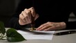 © Mani - A person's hand is carefully pressing a traditional wax seal or an official stamp onto a legal document or contract placed on a professional desk.