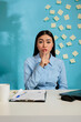 © DC Studio - Business woman making silent gesture with index finger on mouth keeping corporate secret. Company employee makes privacy sign to keep confidentiality and ask for silence, seated at work station.
