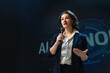 © Konstantin Yuganov - Confident Female Speaker Delivering Keynote at Technology Confer