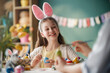© Konstantin Yuganov - Joyful Girl Wearing Bunny Ears Painting Easter Eggs at Home with Family