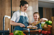 © Konstantin Yuganov - Happy Family Cooking Together in Modern Kitchen, Mother and Daughter Preparing Healthy Meal
