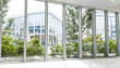 © Westend61 - Modern hotel lobby with large windows plants and urban city view