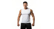 © Ahmad - Muscular man in white tank top and black shorts standing against a plain white studio background posing