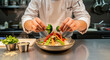 © cornelis - Chef garnishing steaming noodle dish with fresh broccoli florets in professional kitchen