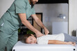 © zinkevych - Physiotherapist supporting girl during back rehabilitation