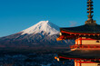 © Travel 'n' Lifestyle - View of the snow-capped Mount Fuji rises majestically behind the vibrant red Chureito Pagoda, a symbol of serenity against the clear blue sky, Fujiyoshida, Chuerito Pagoda, Japan.