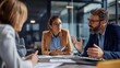 © mussab - Serious business professionals engage in an intense discussion around the conference table while reviewing important documents during a crucial corporate meeting.