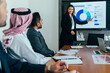 © oneinchpunch - Businesswoman presenting expenses data to multiethnic corporate team in office