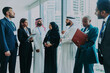 © oneinchpunch - Multiethnic business team collaborating in international dubai office