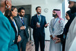 © oneinchpunch - Multiethnic business team meeting in dubai office discussing global corporate strategy