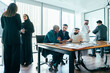 © oneinchpunch - International corporate business team meeting in dubai office