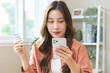 © KMPZZZ - Health care asian young woman using smart mobile for reading, searching prescription medicine, pills label text about medical information online, instructions side effects, pharmacy medicament concept