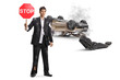 © Ljupco Smokovski - Shocked man in a torn suit holding a stop traffic sign after a car accident