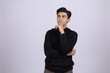 © Midea  - Thoughtful young man leaning on his hand in a studio setting